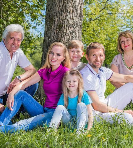Multi-generational family gathered outdoors, representing legacy protection through estate planning in Boca Raton