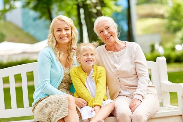 Three generations of women smiling outdoors, representing family legacy and estate planning in Weston