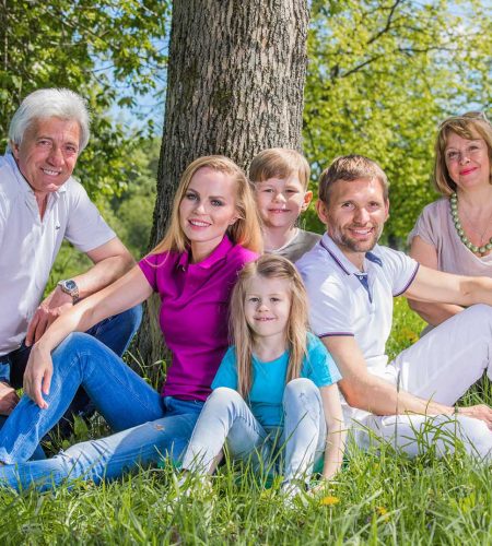 Multi-generational family gathered outdoors, representing legacy protection through estate planning in Boca Raton